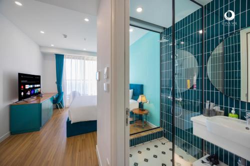 a hotel room with a bed and a bathroom at Luna Sol Villas - Dedicated Care Until Check Out in Phu Quoc