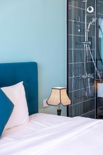 a bedroom with a bed and a shower at Luna Sol Villas - Dedicated Care Until Check Out in Phu Quoc