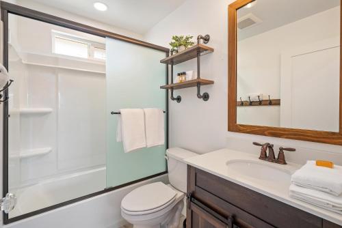 a bathroom with a sink and a toilet and a mirror at Stampede Loft at The 8 Mile in Santa Margarita