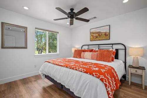 a bedroom with a bed and a ceiling fan at Stampede Loft at The 8 Mile in Santa Margarita