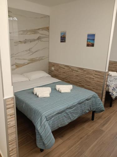 una camera da letto con un letto con due asciugamani sopra di La Casa Di Selene a Trapani