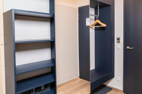 a room with a blue door and shelves at Summit of Saxony Resort Oberwiesenthal in Kurort Oberwiesenthal