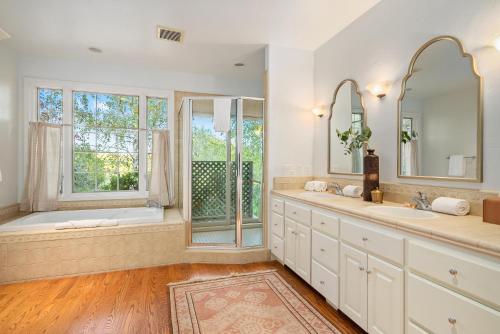 a bathroom with two sinks and a bath tub and a window at G2N - G2 North Vineyard in Paso Robles