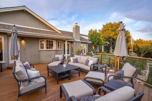 a patio with chairs and tables and umbrellas at G2N - G2 North Vineyard in Paso Robles