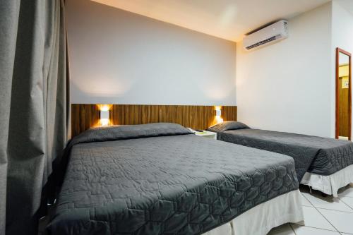 a bedroom with two beds in a room at El Aram Natal Mar in Natal