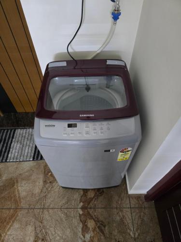 a printer sitting on the floor next to a wall at MAS Residency in Ernakulam