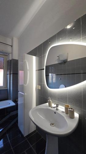 a bathroom with a sink and a mirror at M&M Apartment in Ponte Lucano
