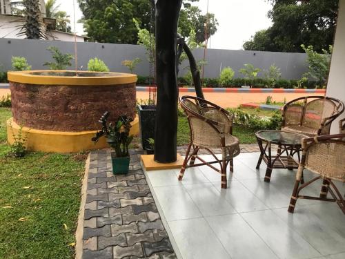 a group of chairs sitting next to a fountain at Mango Hacienda in Kuchchaveli
