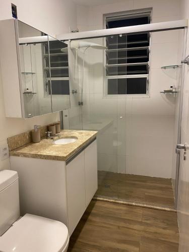 a bathroom with a shower and a toilet and a sink at 24 Melhor custo benefício Aeroporto e Consulado in Porto Alegre