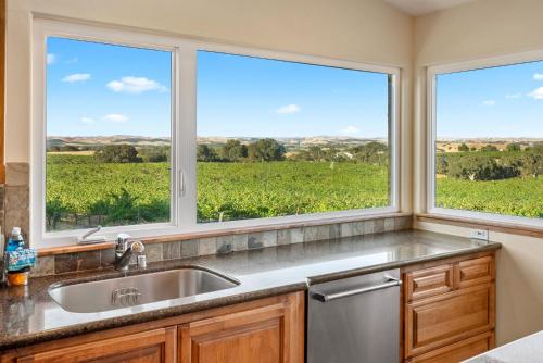 a kitchen with a sink and two windows at Wild Vines in Paso Robles