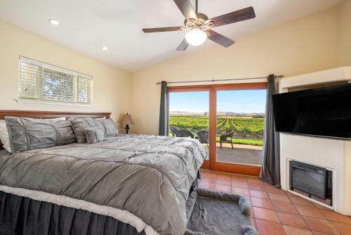 a bedroom with a bed and a flat screen tv at Wild Vines in Paso Robles