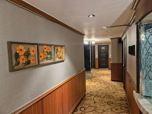 a hallway of a hotel with flowers on the wall at Bongrae Motel in Incheon
