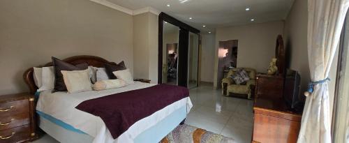 a bedroom with a bed and a tv in a room at Nature's Retreat in Willowdene