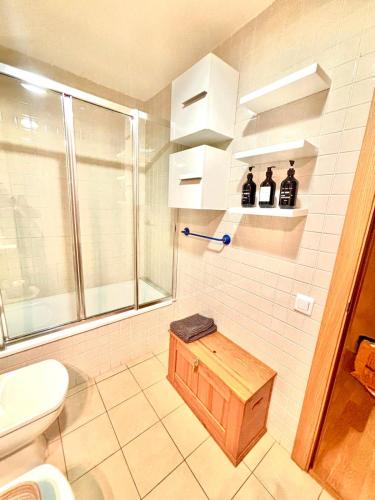 a bathroom with a shower and a toilet and a sink at APARTAMENTO L AÜT in Pla de l'Ermita