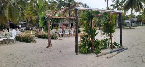a ceremony on the beach with tables and chairs at Cabaña La Niña Cande-Punta Bolivar in San Antero