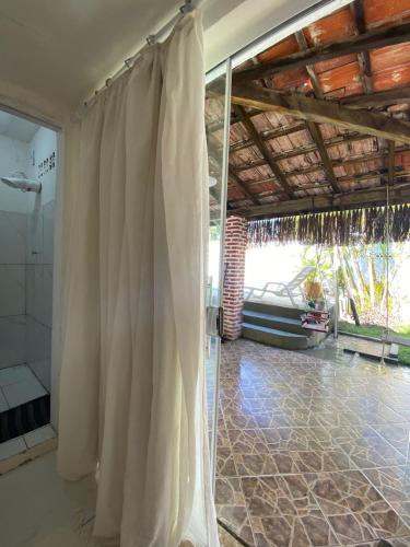 a bathroom with a shower and a shower curtain at Hostel Itaparica Casa in Itaparica