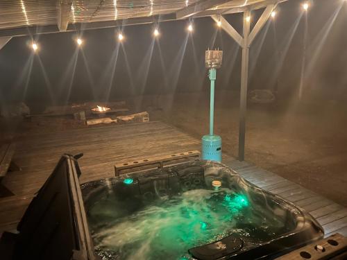 a hot tub with green lights in a room at Chinook Winds Lodge in Dubois