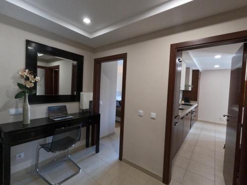 a home office with a desk and a mirror at Oasis by Templesuites - Praia da Rocha in Portimão