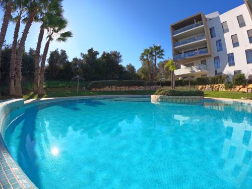 a large swimming pool in front of a building at Oasis by Templesuites - Praia da Rocha in Portimão