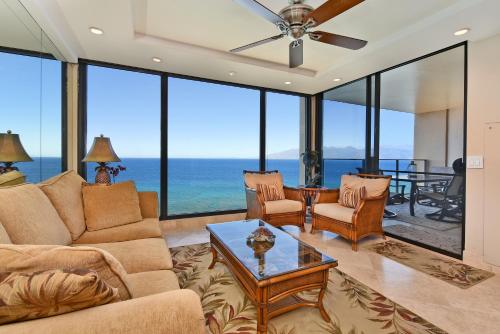 a living room with a couch and a table at Top Floor Penthouse at The Mahana in Lahaina
