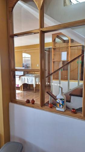 a window with a view of a dining room at kuntur inn hotel in Puno
