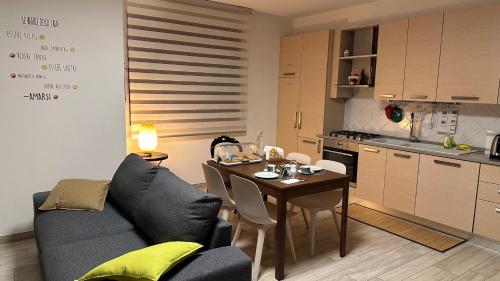 a living room with a couch and a table in a kitchen at La Casa di Gemma B&B in Villa Vomano