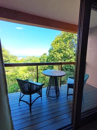 a view of a deck with a table and chairs at Studio Ágata - Praia do Silveira - Garopaba in Garopaba