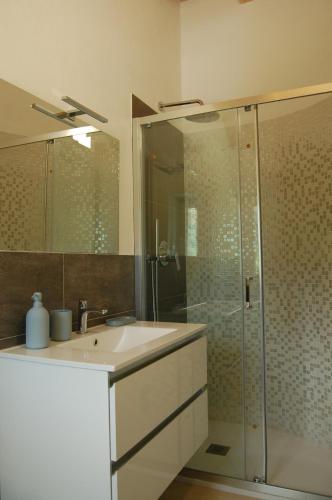 a bathroom with a sink and a glass shower at Villa nel verde con vista mare, Rapallo in Rapallo