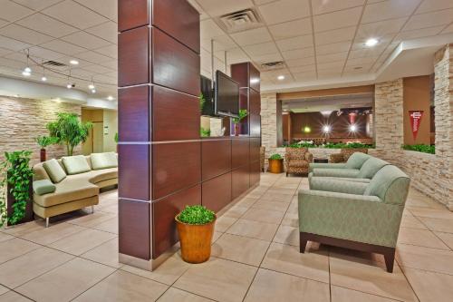 a lobby of a hospital with couches and chairs at Holiday Inn Bloomington-University Area by IHG in Bloomington