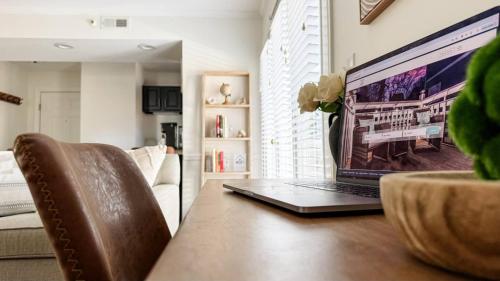 a laptop computer sitting on top of a wooden table at Villa Signor in Norwich