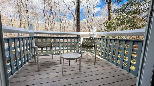 a porch with a table and chairs on a deck at Villa Signor in Norwich