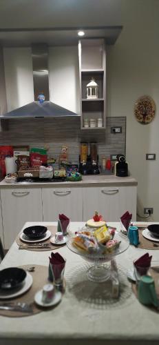 a kitchen with a table with plates of food on it at La Rosa del Salento in San Cesario di Lecce