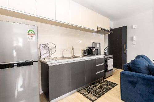 a kitchen with a sink and a stove at Syokimau Furnished Apartments in Nairobi