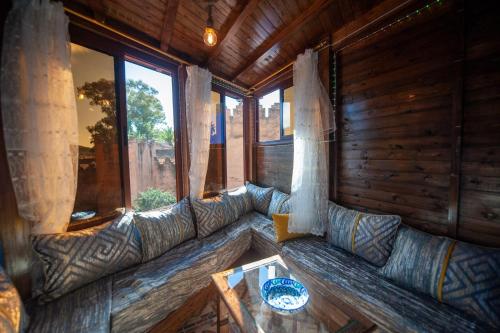 a large couch in a room with a table at Dar Lala Rahma in Chefchaouene