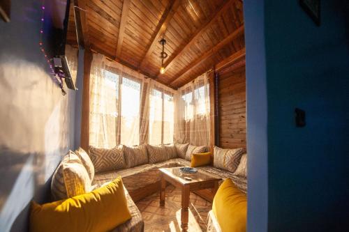 a living room with a couch and a window at Dar Lala Rahma in Chefchaouene