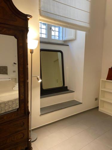 a bathroom with a mirror and a window at Casa Felice Apartment in Orvieto