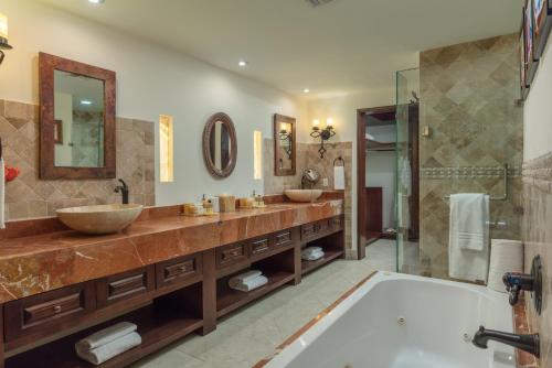 a bathroom with two sinks and a tub at Vista Encantada Resort & Spa Residences, A La Carte All Inclusive Optional in Cabo San Lucas