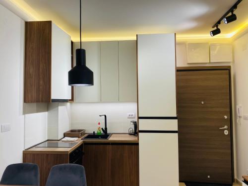 a small kitchen with a counter and a door at Magnet 48 Zlatibor in Zlatibor