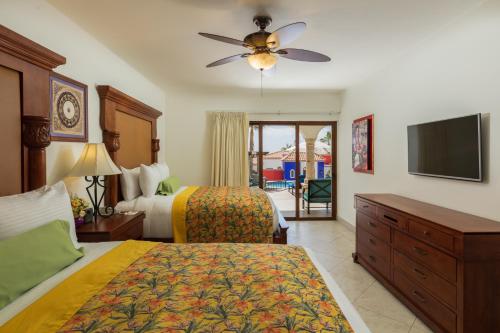 a hotel room with two beds and a flat screen tv at Vista Encantada Resort & Spa Residences, A La Carte All Inclusive Optional in Cabo San Lucas