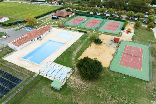 - une vue sur la piscine et les courts de tennis dans l'établissement Camping Paradis Les Rives de l'Adour, à Saint-Sever