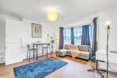 a living room with a couch and a table at Central 1bed flat - 10 Min to Northern Line - Workspace - Parking - New Memory Foam Sofabed in Colindale