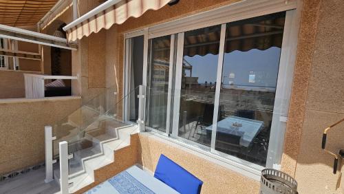 a balcony with blue chairs and a view of the city at CostaBlanca Sunrise in Arenales del Sol