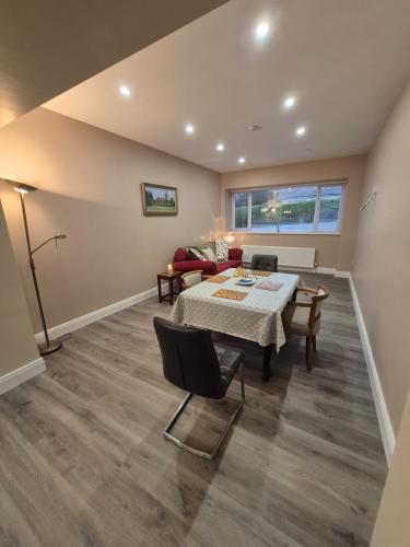 a living room with a table and a couch at Cullen House in Cullen