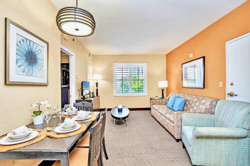 a living room with a couch and a table at Modern Studio Apartment with Hot Tub & Pool Near Universal Studios in Orlando