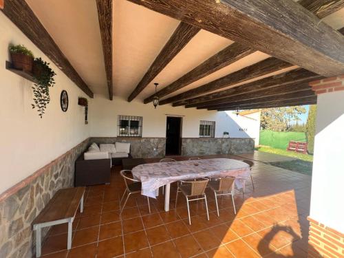 a living room with a table and a couch at Villa Antaquira in Antequera