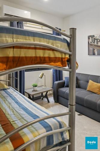 a living room with two bunk beds and a couch at Torre con roof garden y piscina vista al mar in Mazatlán