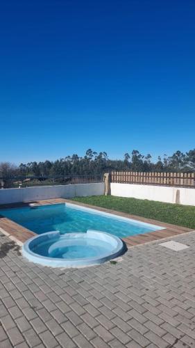 a small swimming pool on a brick patio at Casa Na Serra - Alagoa Blue in Oliveira de Frades