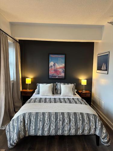 a bedroom with a large bed with a black wall at Downtown Studio with Full Kitchen and Bath in Indianapolis