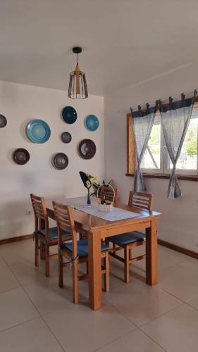 a dining room table with chairs and plates on the wall at Casa Na Serra - Alagoa Blue in Oliveira de Frades