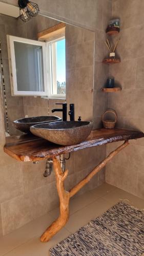a bathroom with a counter with a sink and a mirror at Casa Na Serra - Alagoa Blue in Oliveira de Frades